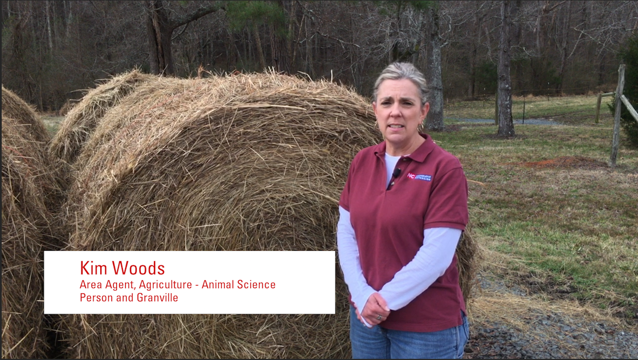 Kim Woods in front of hay.